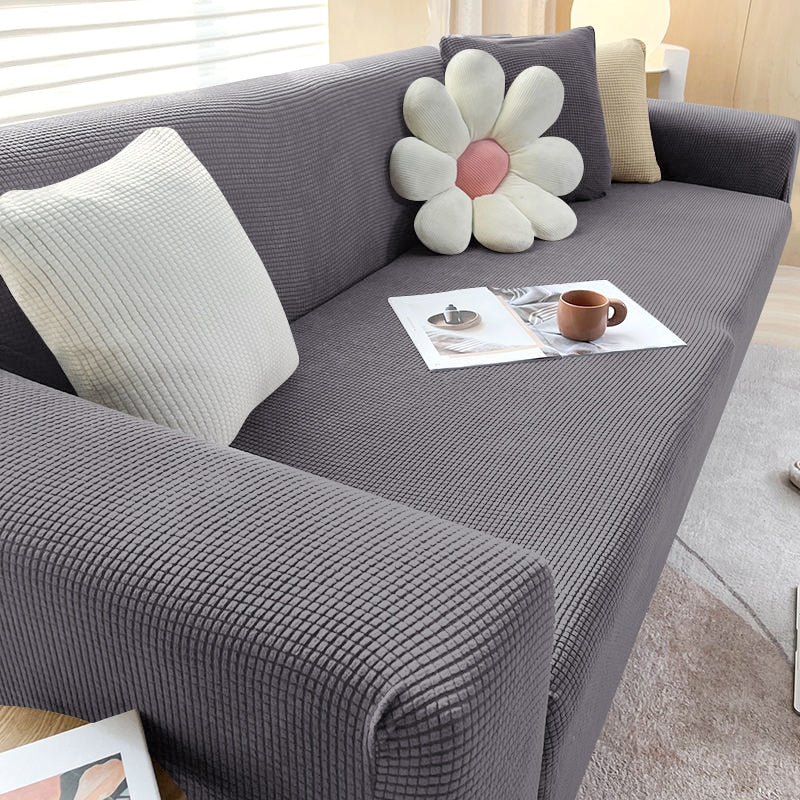 Beige Sofahusse aus elastischem Stretchmaterial, perfekter Sitz, Schutz vor Flecken, Schmutz und Tierhaaren.