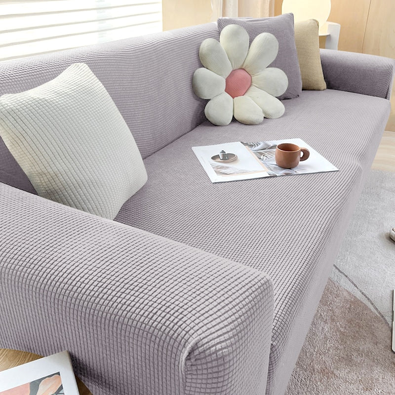 Beige Sofahusse aus elastischem Stretchmaterial, perfekter Sitz, Schutz vor Flecken, Schmutz und Tierhaaren.