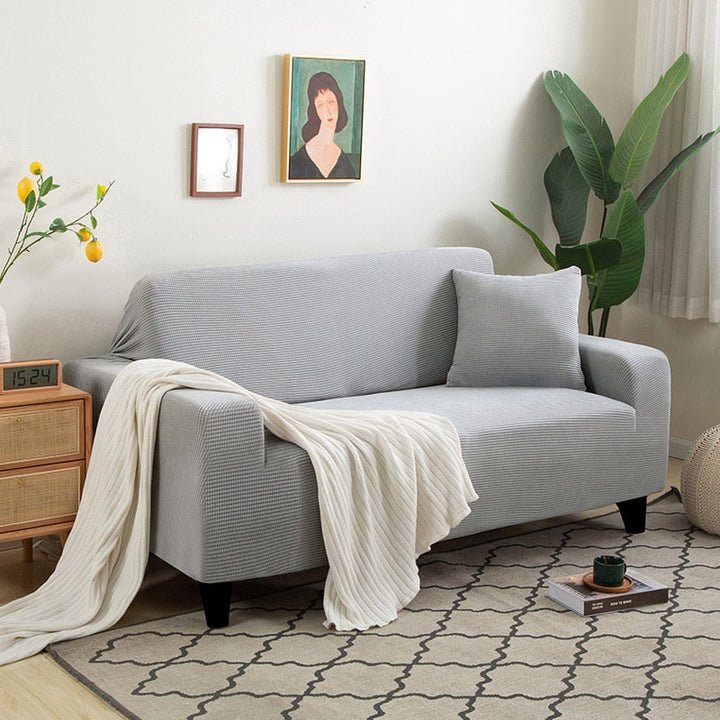Beige Sofahusse aus elastischem Stretchmaterial, perfekter Sitz, Schutz vor Flecken, Schmutz und Tierhaaren.