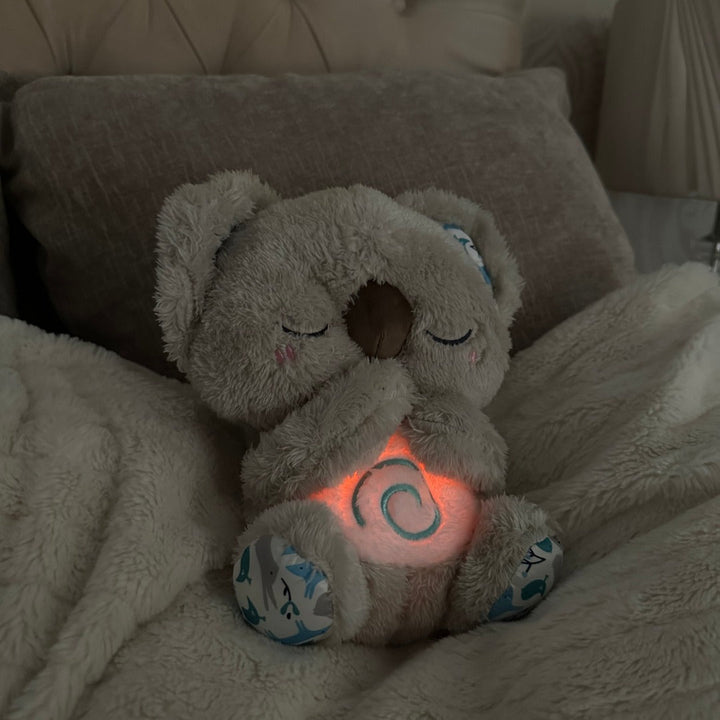 "Beruhigendes Koala-Atemspielzeug für Kinder, simulierende Atembewegung, sanfte Farben und integriertes Nachtlicht."
