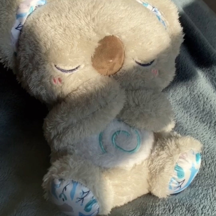 "Beruhigendes Koala-Atemspielzeug für Kinder, simulierende Atembewegung, sanfte Farben und integriertes Nachtlicht."
