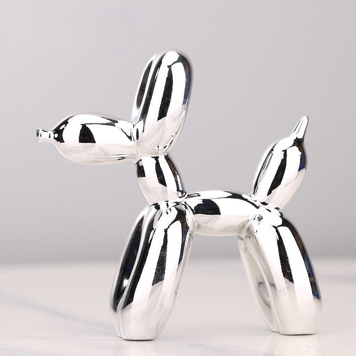 "Kupferfarbene Ballonhund Skulptur, verspieltes Deko-Objekt mit glänzender Metalloberfläche, ideal für Wohnräume."