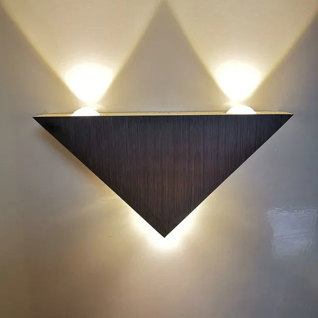 "Moderne dreieckige LED-Wandleuchte aus Aluminium, PrismShine, für stilvolle Raumakzente und gemütliches Licht."