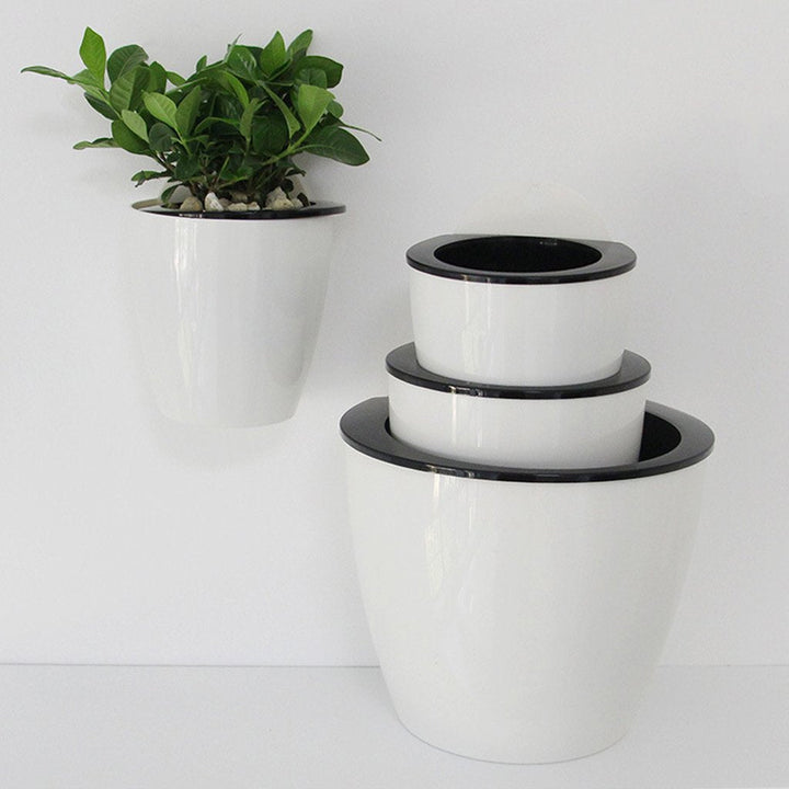 "Moderner, selbstbewässernder Hängepflanztopf mit stilvollem Design für Wandmontage – ideal für drinnen und draußen."