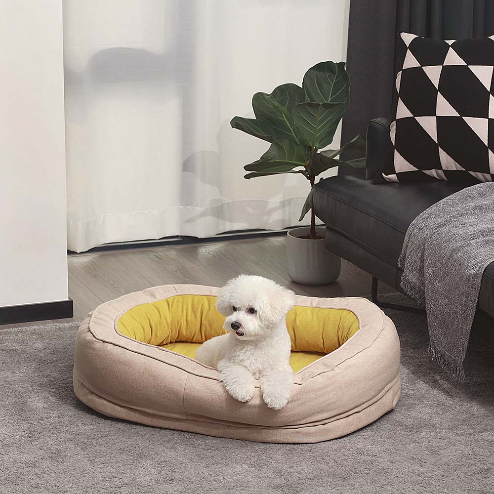 "Orthopädisches flauschiges Haustierbett in Donutform, beige, für Hunde, bietet Komfort und Unterstützung auf glatten Böden."