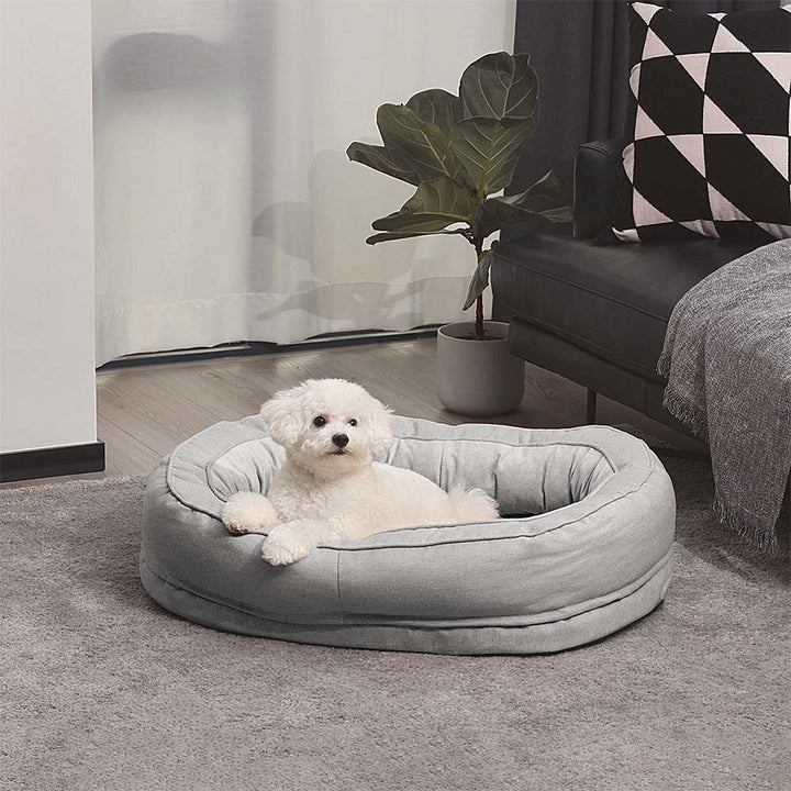 "Orthopädisches flauschiges Haustierbett in Donutform, beige, für Hunde, bietet Komfort und Unterstützung auf glatten Böden."