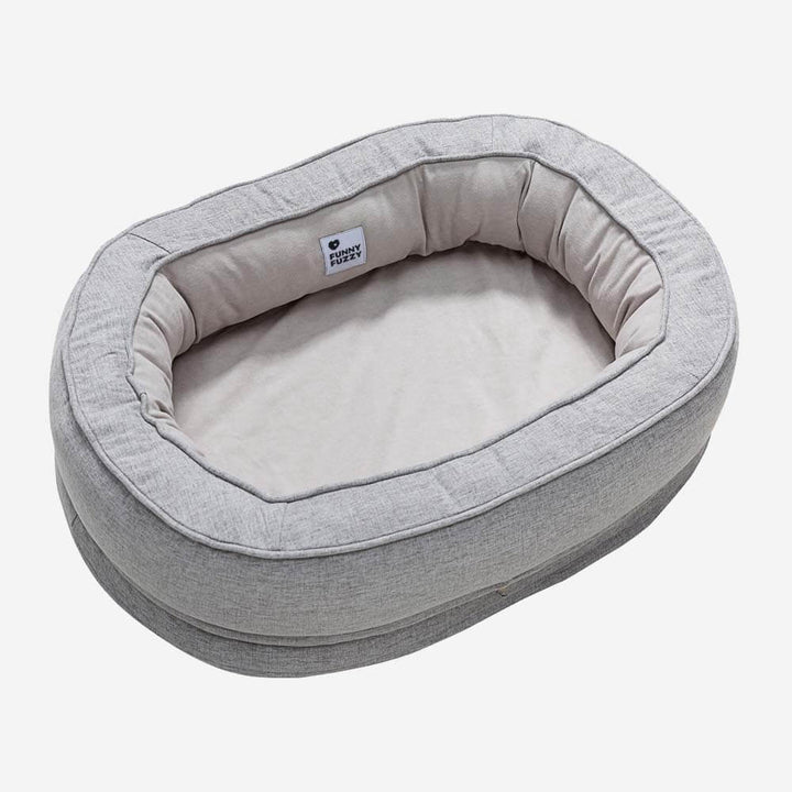 "Orthopädisches flauschiges Haustierbett in Donutform, beige, für Hunde, bietet Komfort und Unterstützung auf glatten Böden."