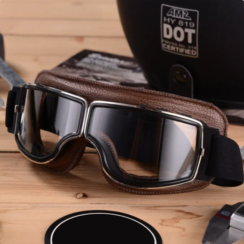 "Vintage Motorradbrille aus Leder, Retro-Stil, splitterfreie Gläser, Schutz vor Wind und Staub, stilvoll und robust."